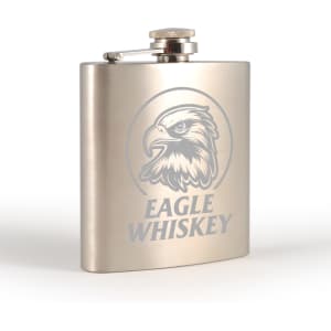 A stainless steel hip flask with an engraved eagle design, featuring a screw-top lid.