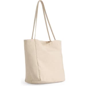 A beige tote bag with long handles and a minimalist design. It has a logo on one side.