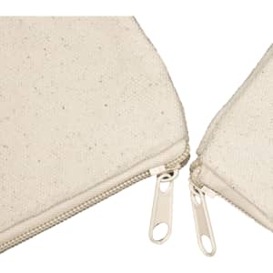 A beige canvas tote bag with a textured surface and two zippered compartments.