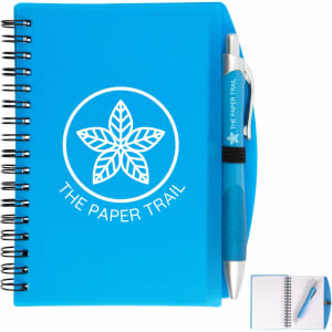 A blue spiral notebook with a matching pen, featuring a logo on the cover and lined pages inside.