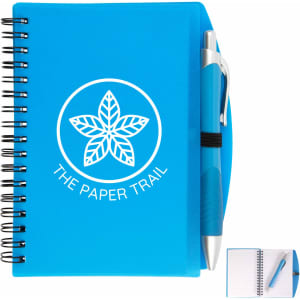 A blue spiral notebook with a pen attached, featuring a logo on the front cover.