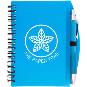 A blue spiral notebook with a pen attached, featuring a logo on the cover.