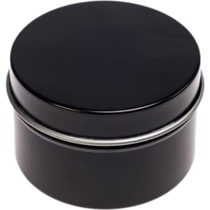 A black tin candle container with a smooth, rounded lid, designed for holding a petite candle.