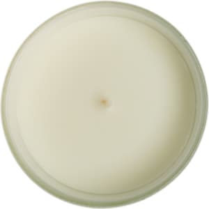 A medium-sized glass candle with a smooth, white wax surface and a single wick at the center.