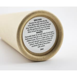 A cylindrical container with a natural beige surface, featuring a label with instructions and warnings.