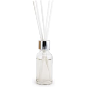 A glass bottle with a silver lid, containing clear liquid and four white reeds for fragrance diffusion.
