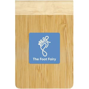 A bamboo notebook featuring a wooden cover and a blue logo for "The Foot Fairy."