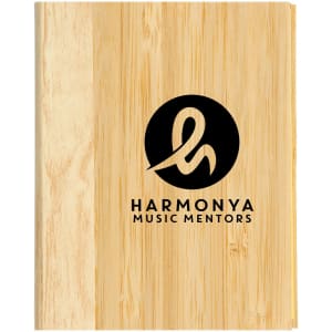 A wooden bamboo cover notebook featuring a circular logo with stylized lettering in black.