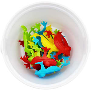 A white bucket containing colourful plastic frogs in red, yellow, green, and blue.