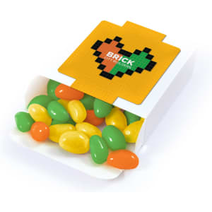 A box of jelly beans in green, yellow, and orange colors, with a branding logo on the packaging.