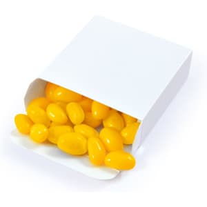 A white box filled with yellow jelly beans, some spilling out of the open packaging.
