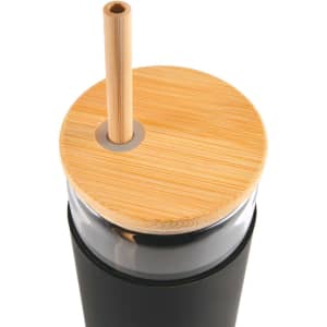 A glass tumbler with a black body, bamboo lid, and a bamboo straw. It features a circular opening for the straw.