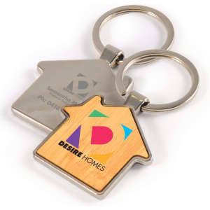 A house-shaped keytag featuring a bamboo and metal design, with a logo on one side.