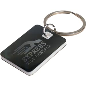 A rectangular stainless steel keytag with a keyring, featuring a dark design and a logo.