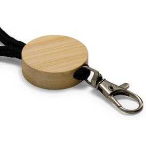 A round bamboo keytag with a black cord and a metal clip attachment.