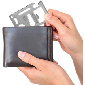 A multi-tool card is being held above a black wallet, showcasing its compact design and versatility.