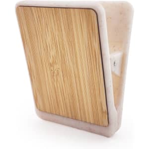 A magnetic clip with a bamboo front and a white plastic backing, featuring a simple design and a mounting option.
