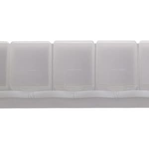 A weekly pill box in translucent white plastic with compartments labeled for each day of the week.