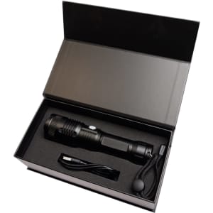 A rechargeable black torch displayed in a black gift box, accompanied by a charging cable and wrist strap.