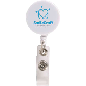 A white retractable name badge holder with a circular top and a metal clip, featuring a logo.