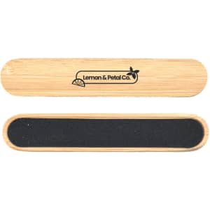 A bamboo nail file with a smooth surface and a dark grit side, featuring a branding logo.