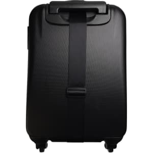 A black suitcase featuring a sleek luggage strap securing it in place.