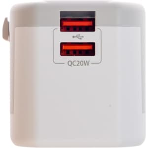 A travel adaptor featuring two USB ports labeled for Quick Charge, designed for international compatibility.