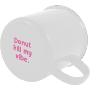 An enamel mug featuring the text "Donut kill my vibe" in pink letters.