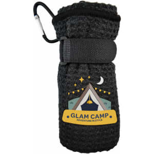 A black travel towel with a textured appearance, secured by a strap and featuring a logo or branding.