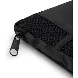A black sports towel with a textured mesh section and a zip fastener, featuring a branding logo.