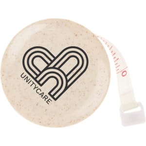 A round, cream-coloured tape measure with a logo and red measurement markings.