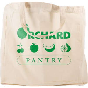 A beige reusable grocery bag with short handles and green branding. Features fruit designs and a logo.