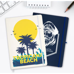 A duo of Capella A4 notebooks featuring a tropical beach design and a navy cover with a logo.
