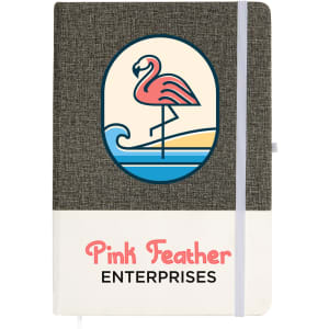 A grey and cream A5 notebook with a decorative flamingo design and a branded logo.