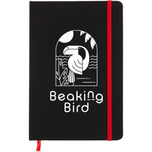 A black A5 notebook featuring a graphic design on the cover, secured with a red elastic band.