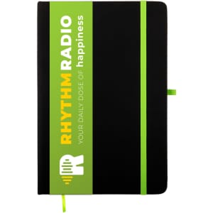 A black A5 notebook with a green and white branded sleeve and a matching green elastic band closure.