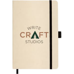 A beige A5 notebook with a black elastic band and a logo centred on the cover.