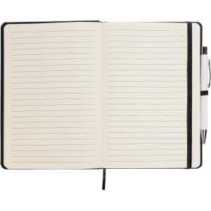An A5 notebook with lined pages, featuring a black cover and a matching pen placed on top.