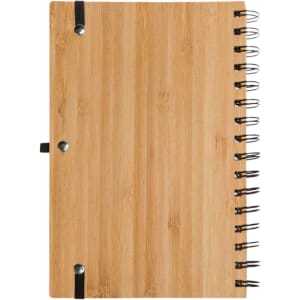 A bamboo notebook with a spiral binding and a black elastic band. It features a sleek and natural wood finish.