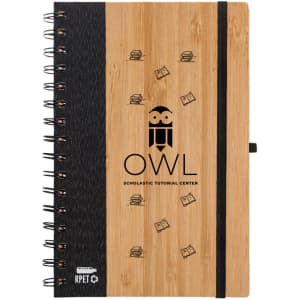 A bamboo notebook with a spiral binding, featuring a logo and design elements in black.