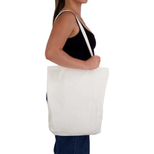 A person holding a long handle bamboo tote bag in natural colour, featuring a simple design and a logo.