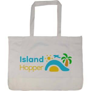 A large reusable grocery bag in cream featuring a colourful logo with a sun, palm tree, and wave design.