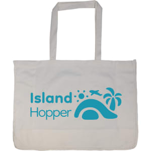 A large, white reusable grocery bag with blue branding featuring tropical elements like a palm tree and an airplane.
