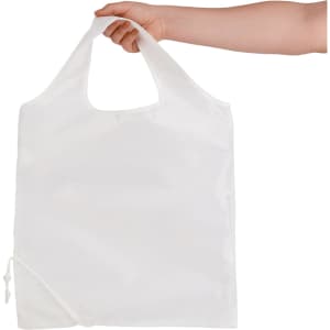 A reusable grocery bag in white, held by a hand, featuring a logo and a foldable design.