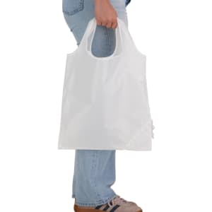A white reusable shopping bag is being held by a person, featuring a structured design and a small logo.