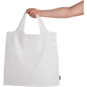 A white reusable grocery bag is held by a hand, featuring a logo on the side.
