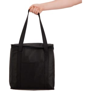 A black cooler bag with sturdy handles being held by a hand. The bag has a front pocket and a zipper closure.