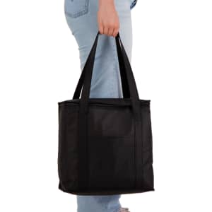 A black cooler bag is being held by a person, featuring sturdy handles and a simple design.