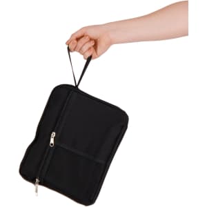 A black utility pouch being held by a hand, featuring a zippered compartment and a mesh pocket.