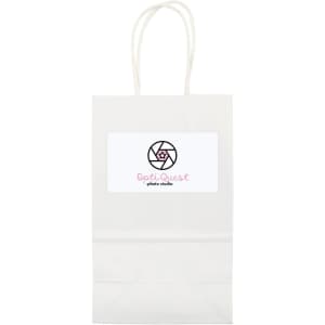 A small white paper bag with two handles and a logo on the front.